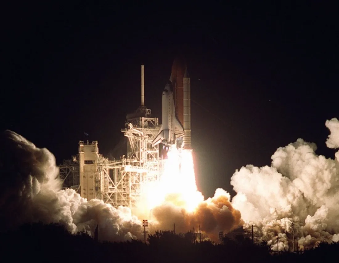 The Space Shuttle Endeavour launching on a column of flame.