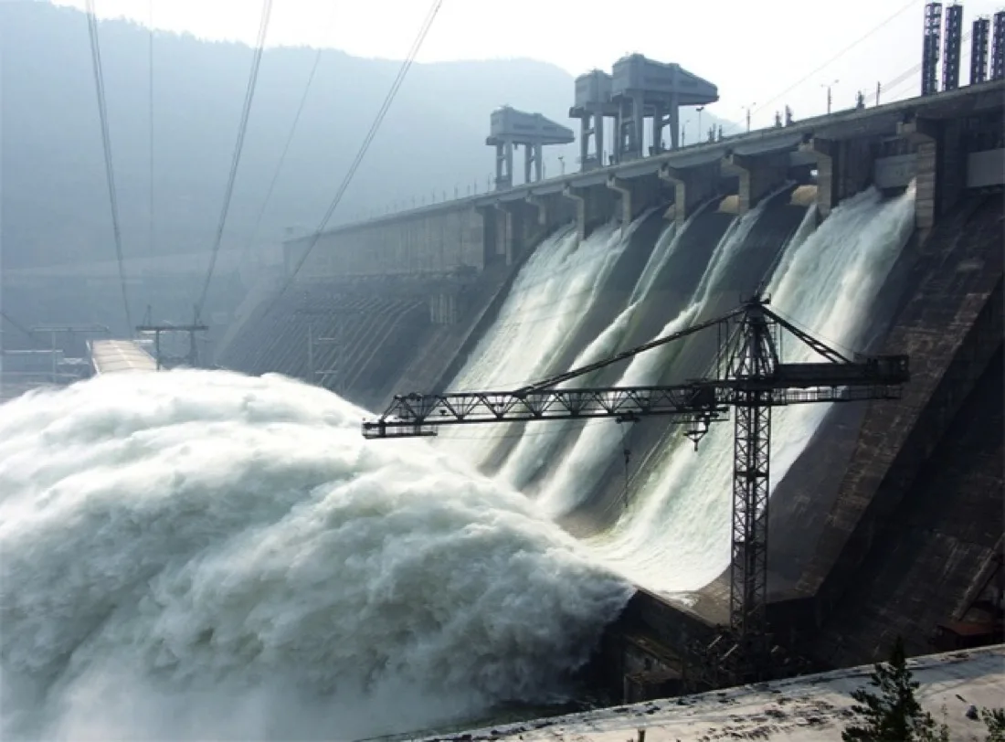 A hydroelectric dam with water discharging from its outlets.